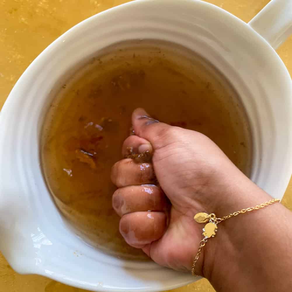 Tamarind Pulp being squeezed in water