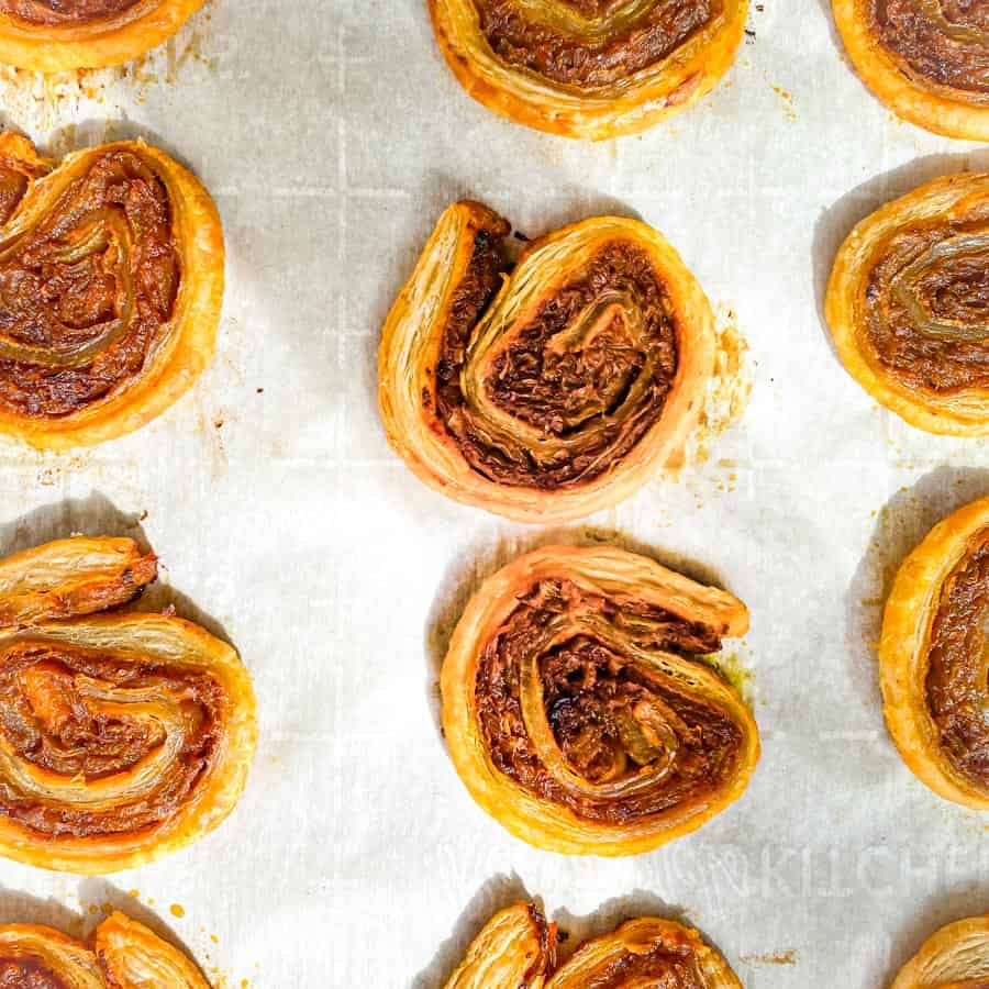 Caramelized Onion Puff Pastry Swirls on a baking sheet