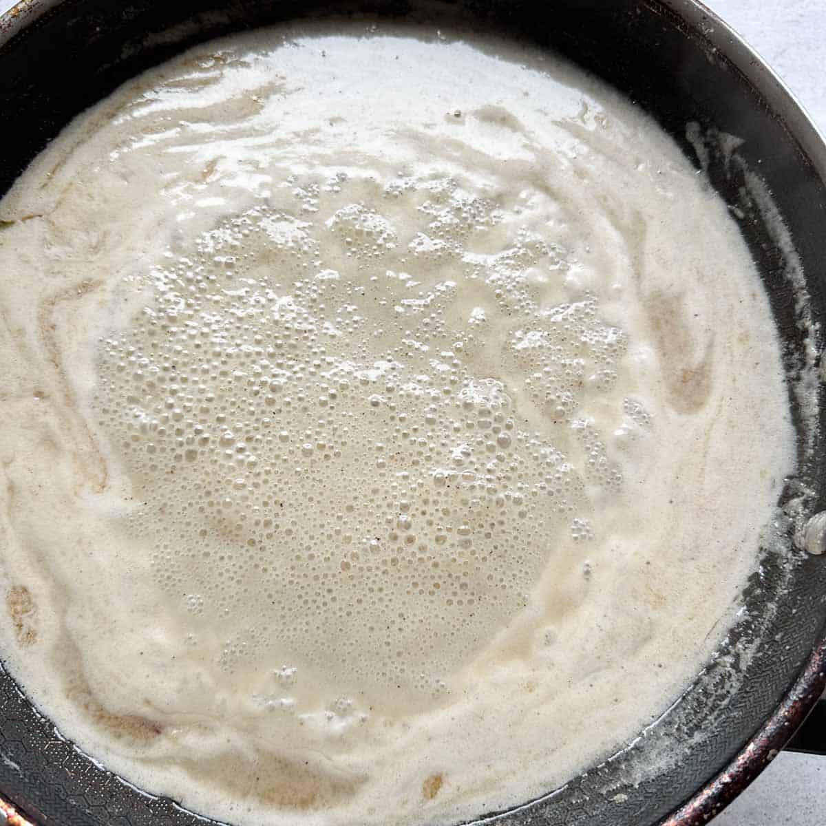 Badam halwa bubbling and reducing in a pan
