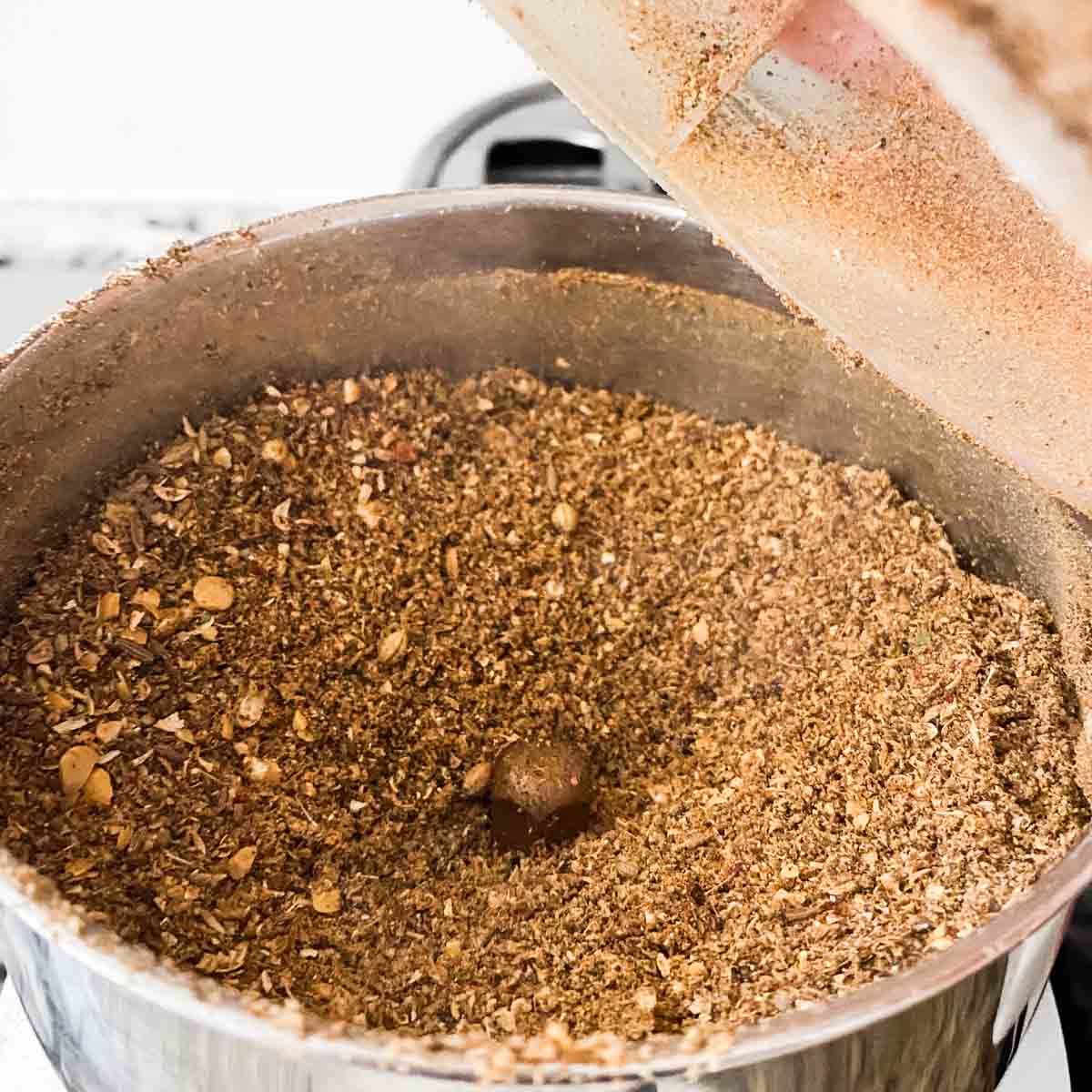 Freshly ground rasam powder in a spice grinder