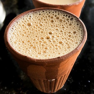 Hot, frothy, masala chai in an Indian clay cup.