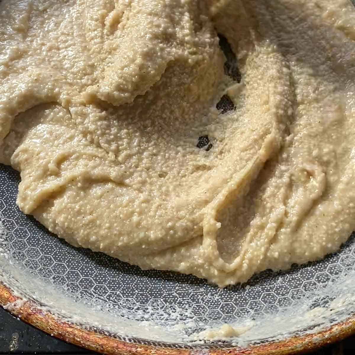 Thick kaju katli dough when finished cooking in a pan