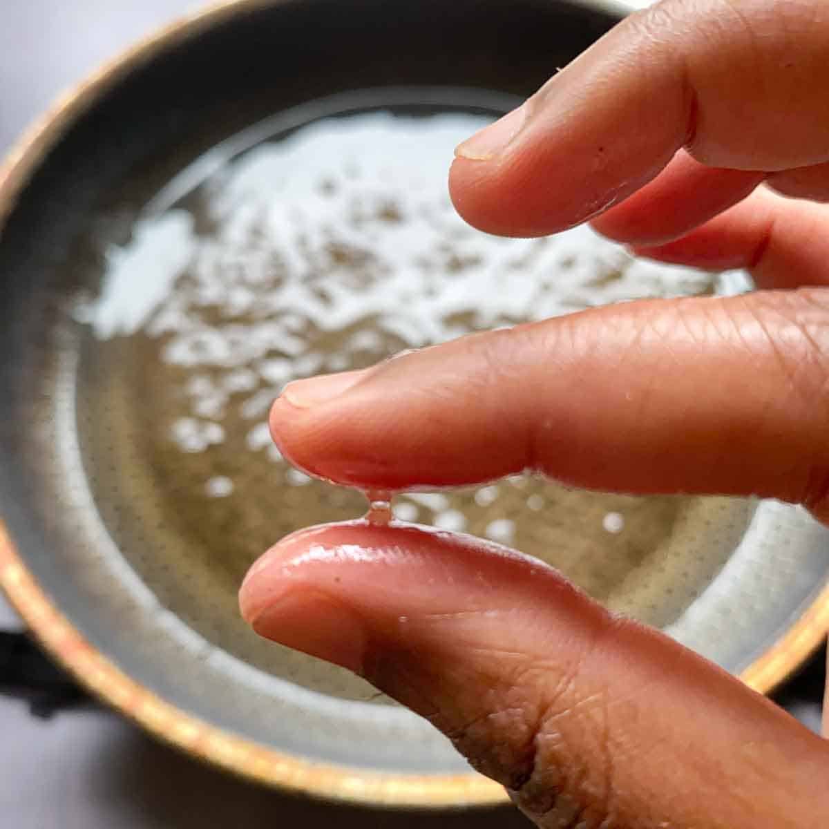 Silky sugar syrup in between two fingers