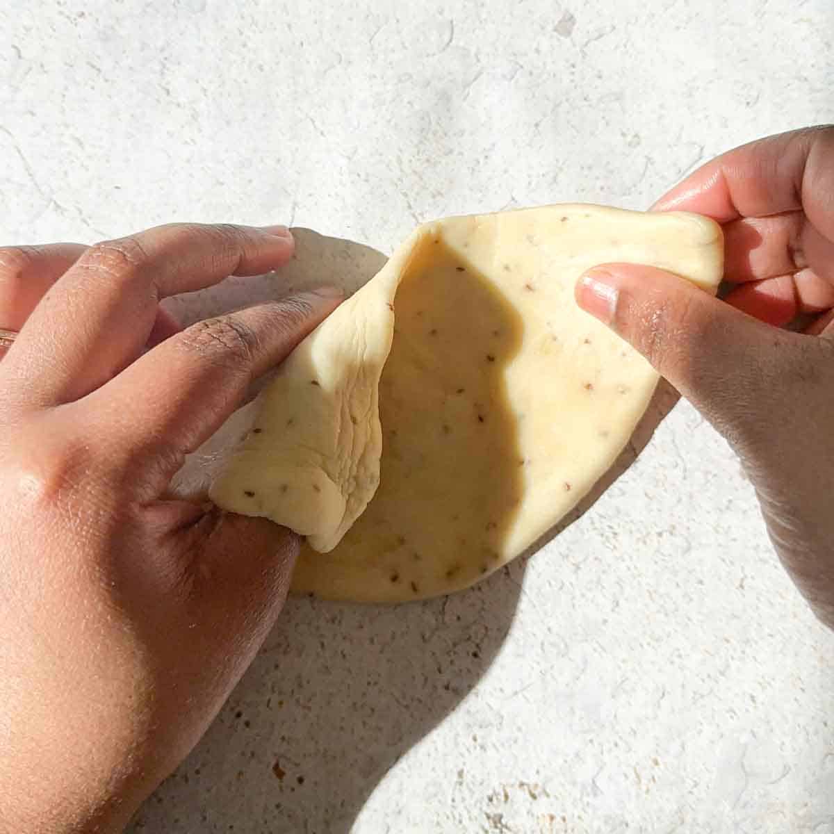Samosa dough being shaped into a cone