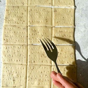 Pricking papdi with holes via a fork to prevent them from puffing