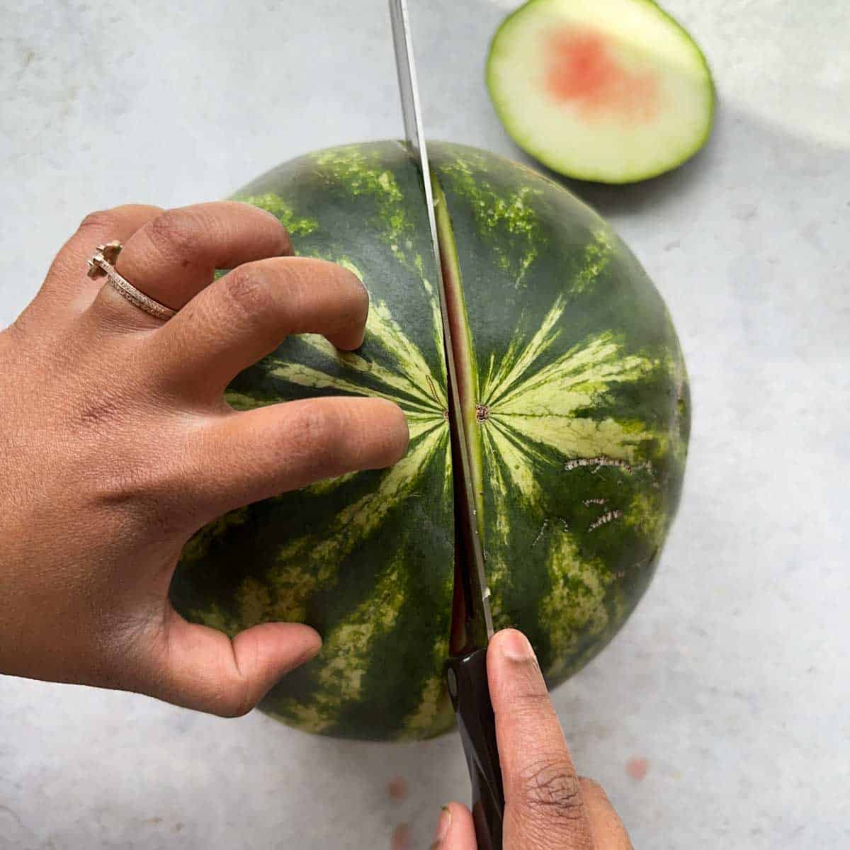 Cutting the watermelon in half