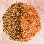 Masoor Dal whole on the left and split and hulled masoor dal (aka red lentil) on the right.