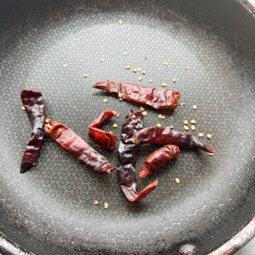 Dried Indian red chilis toasting on a skillet