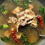 A big bowl of mutton bone broth soup in a gray bowl.