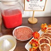 Watermelon chaat juice station setup with juice, garnishes, and spices for the rim.