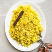 A plate with Indian turmeric yellow rice.