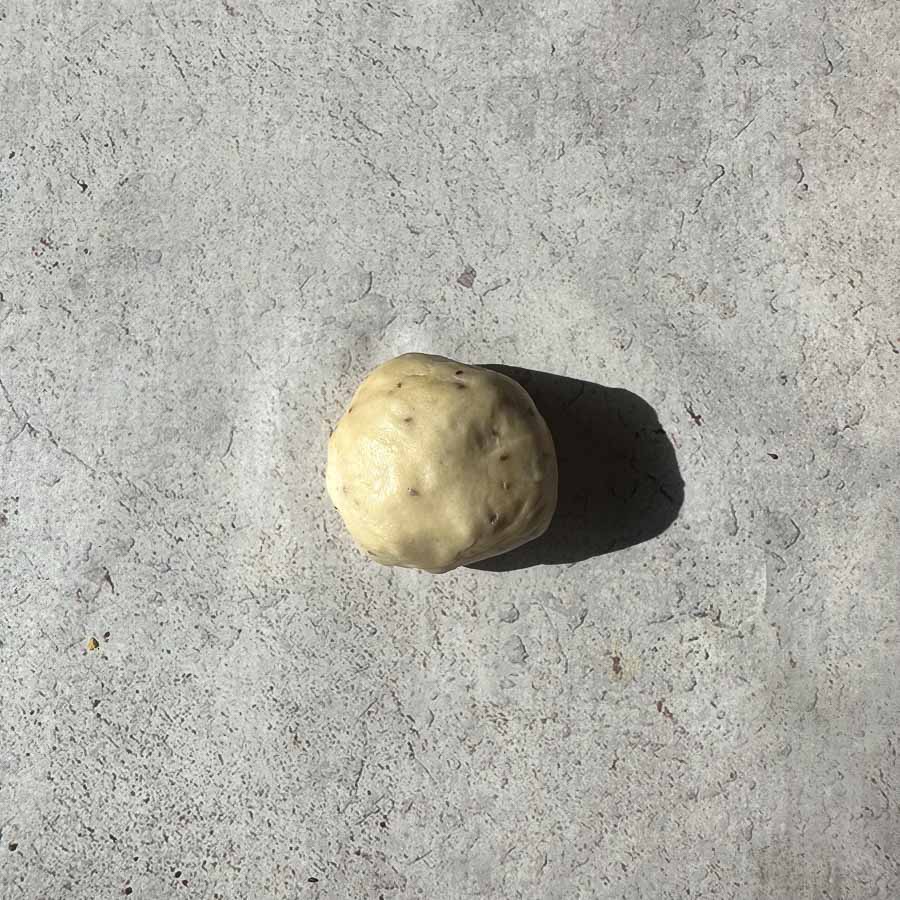 A 90 gram ball of samosa dough that has been rested.