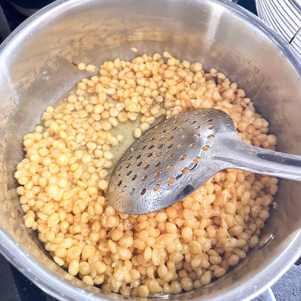 Boondi soaked in saffron and cardamom syrup.